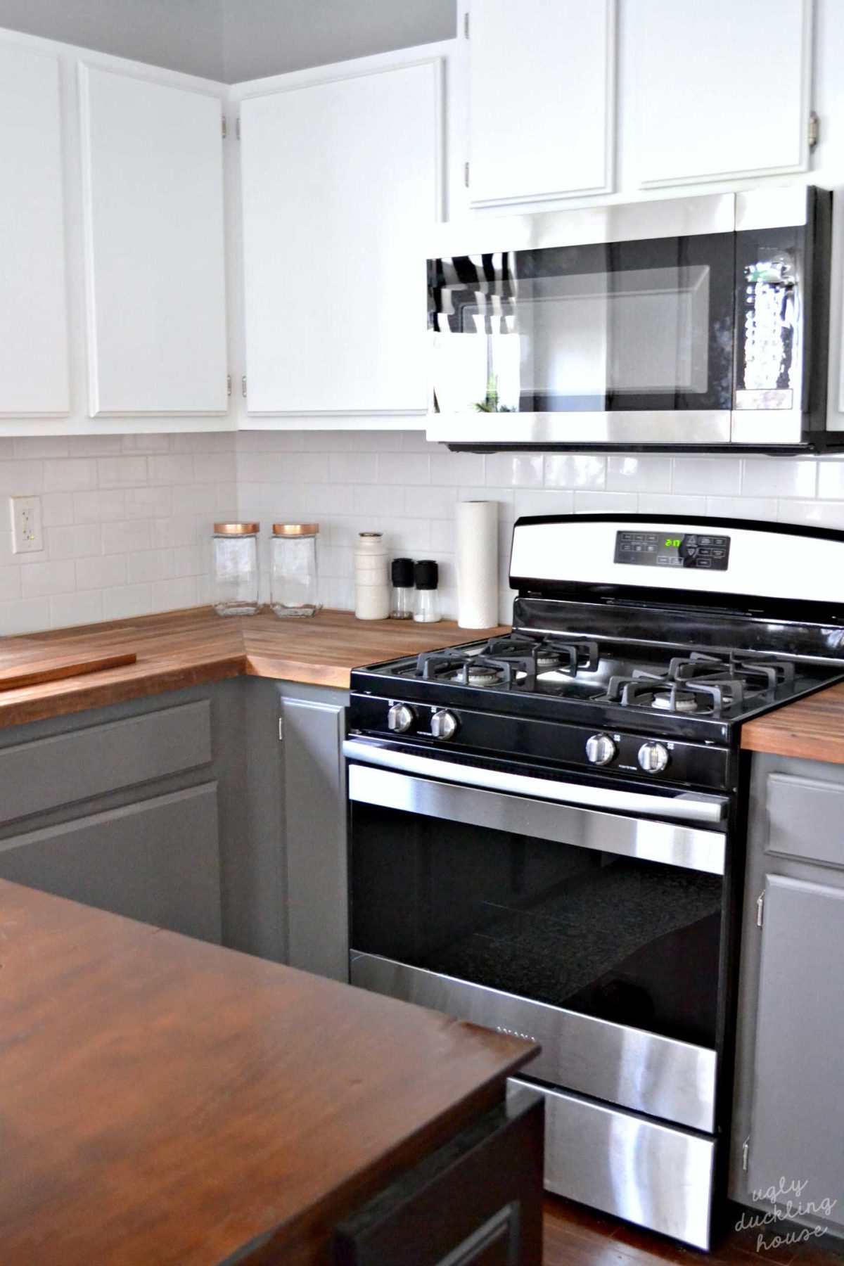 white upper cabinets gray lower cabinets kitchen with stainless appliances