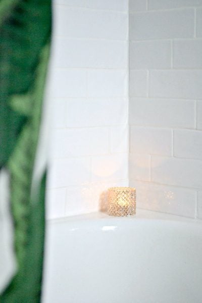 white shower tile with green palm leaf shower curtain
