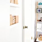white doors inside office with picture ledges and bookshelf