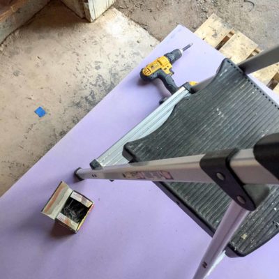 looking down on stack of purple drywall