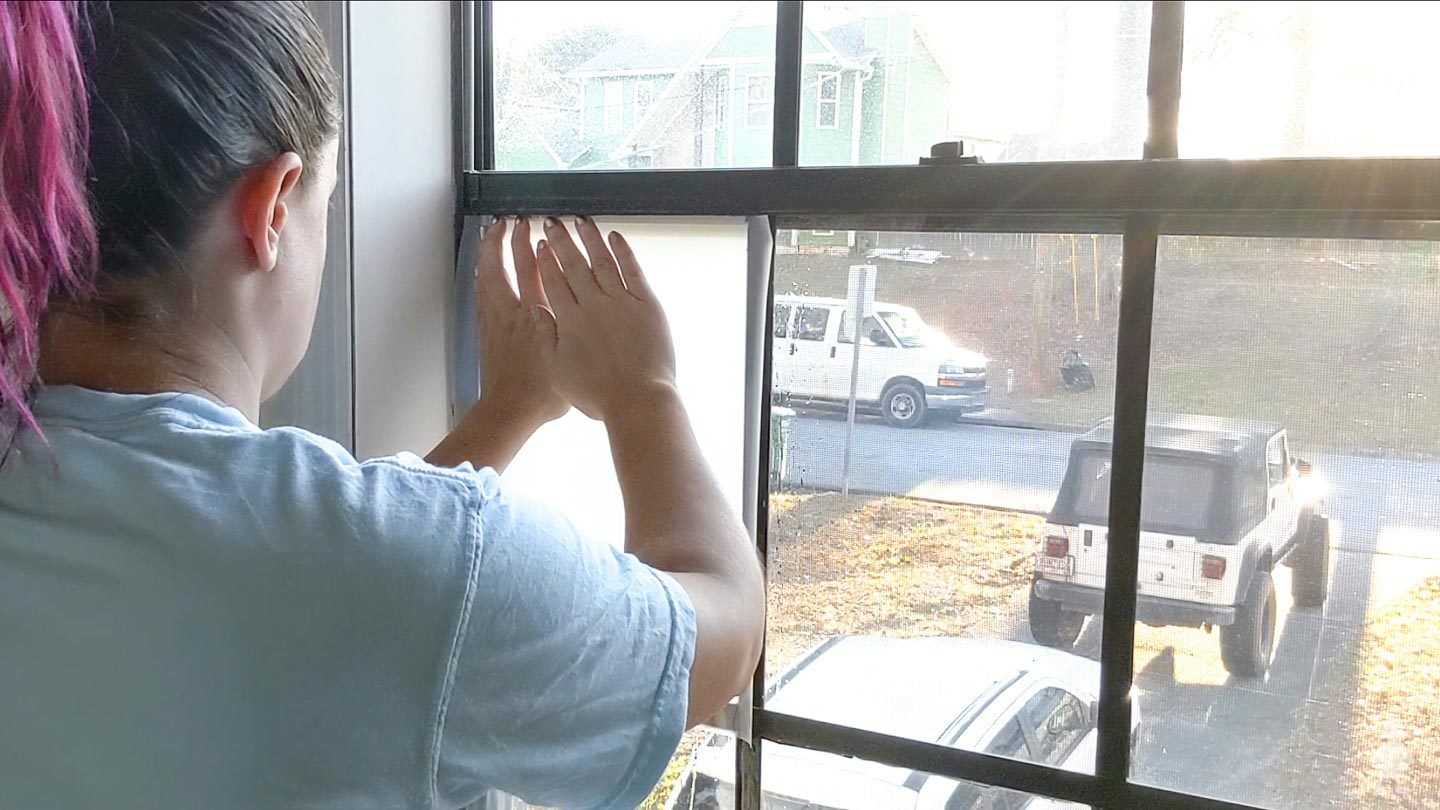 lined up straight edge along top of window pane