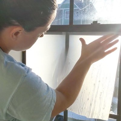 separate backing from film and apply to window