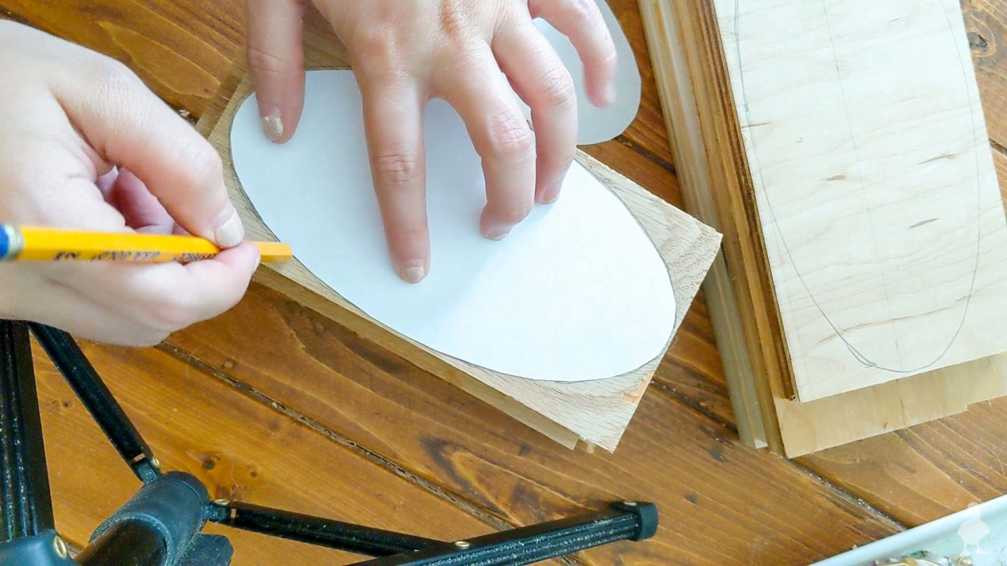 tracing oval shape to the top of the stack of plywood