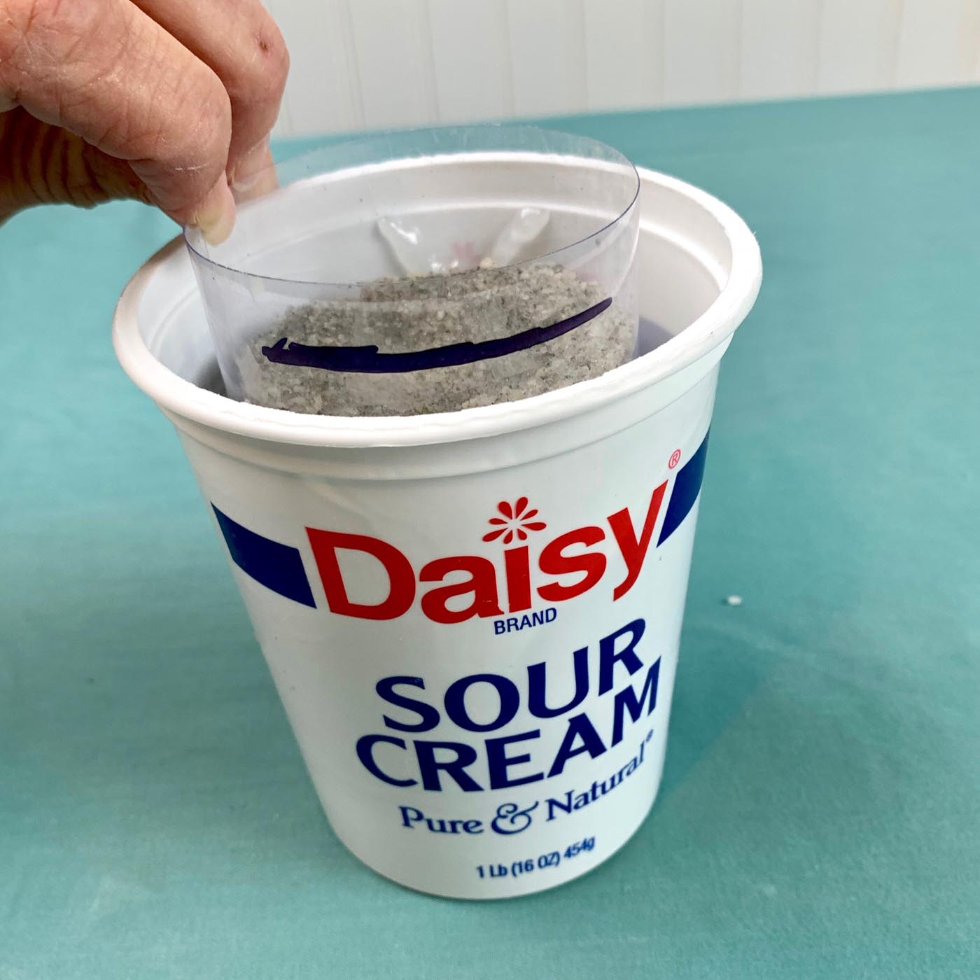 container inside of container with sand