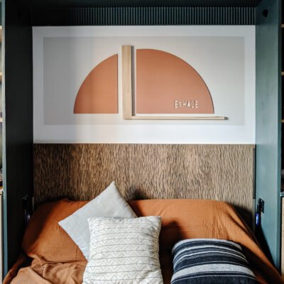 murphy bed nook reveal - exhale rust arch color block art and carved wood headboard with neutral bedding and rust coverlet