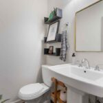 first floor powder room with floating shelves