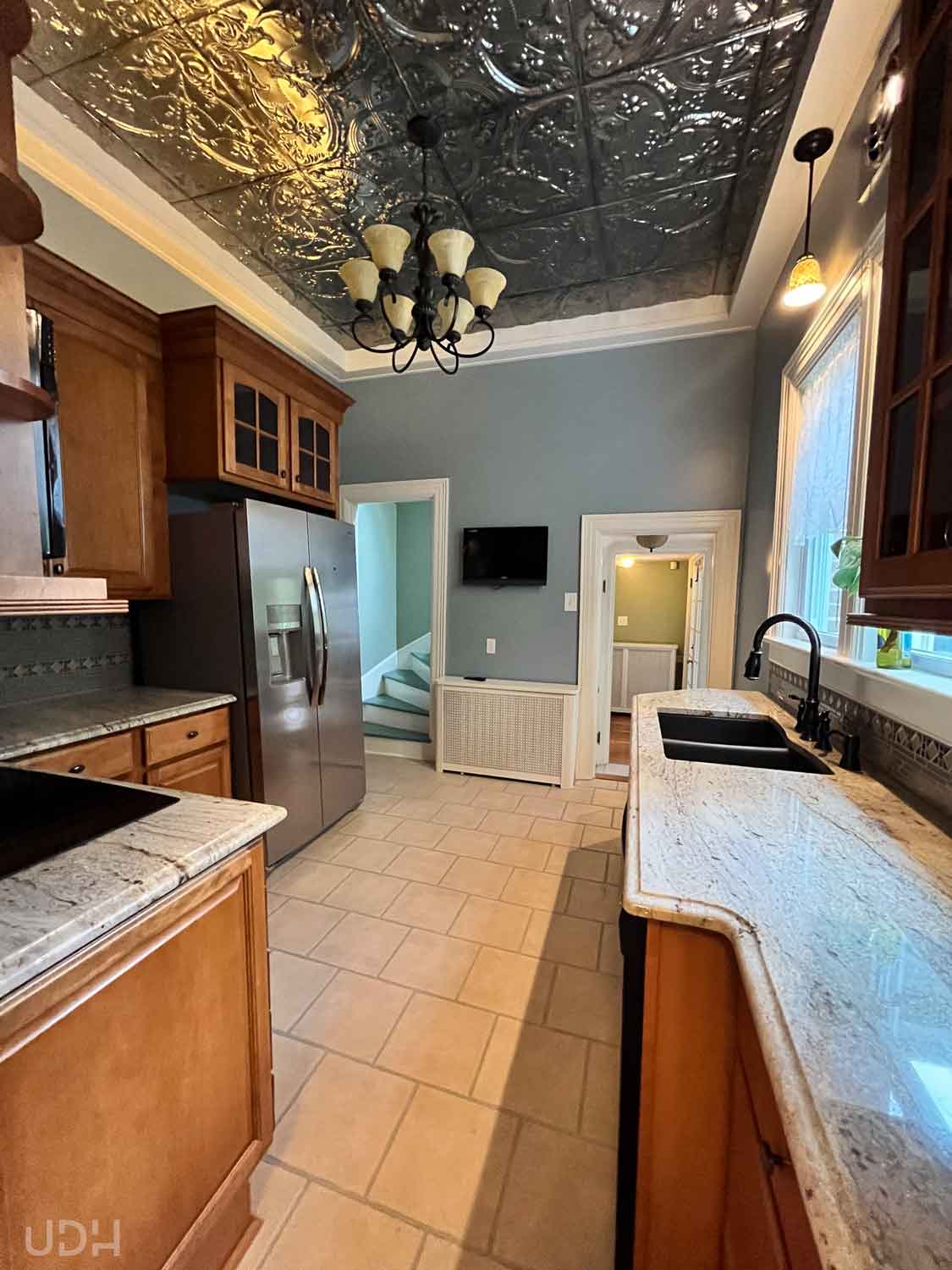 colonial revival kitchen with tin ceiling and wood cabinets